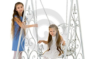 Girls swing on a swing.Isolated on white background.