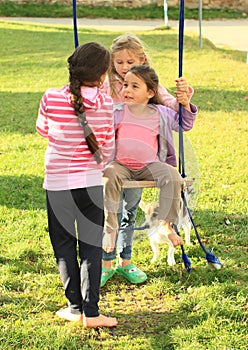 Girls swinging on swing