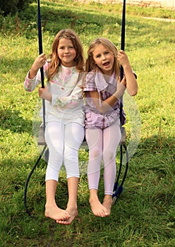 Girls swinging on swing