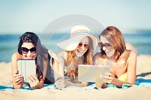 Girls with tablet pc on the beach