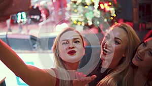 Girls take selfie on camera smartphone at a concert