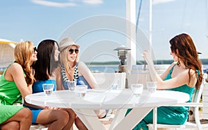 Girls taking photo in cafe on the beach