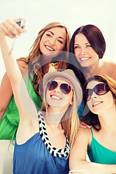 Girls taking photo in cafe on the beach