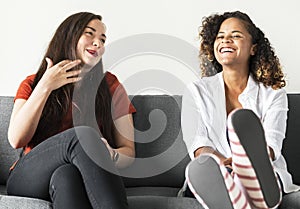 Girls talking together on a couch