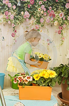 Girls of three years care for flowers,