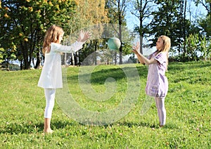 Girls throwing a ball photo