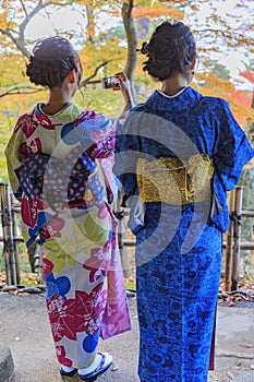 Girls in traditional Kimono in kanazawa garden in autumn.