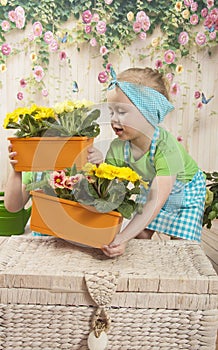 Girls twins of three years care for flowers,