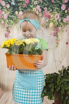 Girls twins of three years care for flowers,