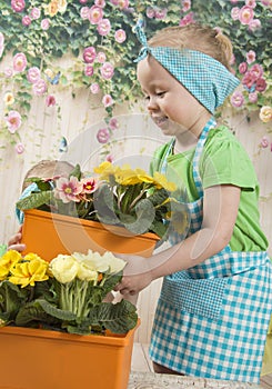 Girls twins of three years care for flowers,