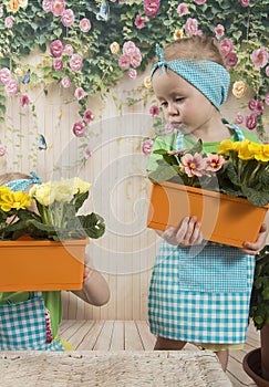 Girls twins of three years care for flowers,