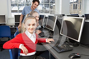 Girls using computers in school class