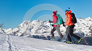 Girls walk with crampons on the snow in the mountains