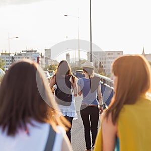 Girls walking across the bridge