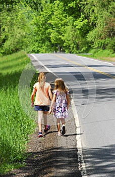 Girls Walking Along Country Road
