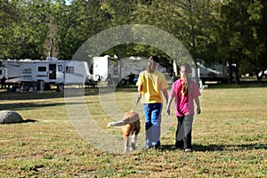 Girls Walking a Dog While Camping