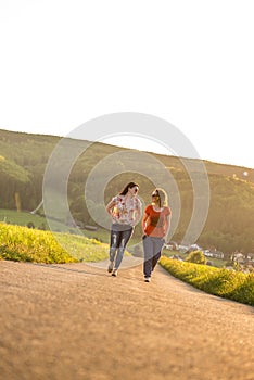 Girls walking on a raod at sunset