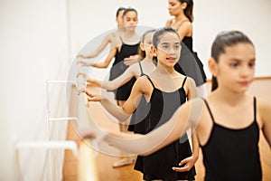 Girls wearing a leotard taking dance class