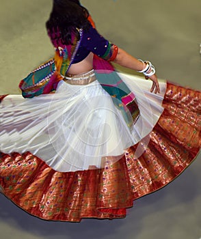 Girls wearing traditional Indian dress performing garba and dandiya dance during Navratri festival Abstract of motion blur effect.