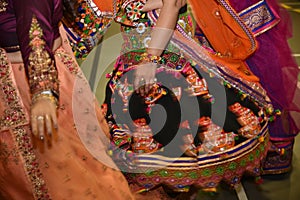 Girls wearing traditional Indian dress performing garba and dandiya dance during Navratri festival Abstract of motion blur effect.