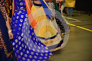 Girls wearing traditional Indian dress performing garba and dandiya dance during Navratri festival Abstract of motion blur effect.