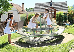 Girls in white dresses on marry-go-round