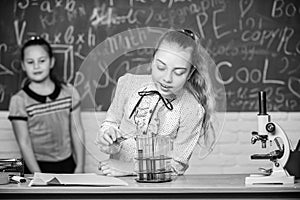 Girls working chemical experiment. Natural science. Educational experiment. School classes. Biology and chemistry