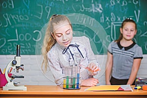 Girls working chemical experiment. Natural science. Educational experiment. School classes. Biology and chemistry