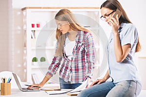 Girls working and talking on phone