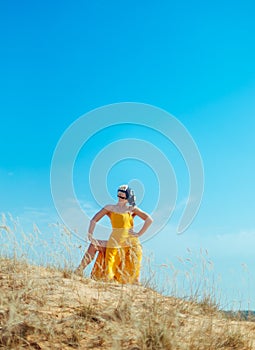 Girls in yellow dress and Gasmask dancing on the sand dunes