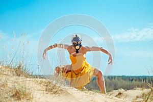 Girls in yellow dress and Gasmask dancing on the sand dunes