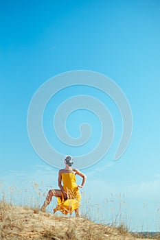 Girls in yellow dress and Gasmask dancing on the sand dunes