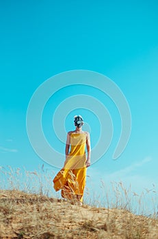 Girls in yellow dress and Gasmask on the sand dunes