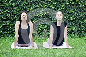 Girls yoga outside park
