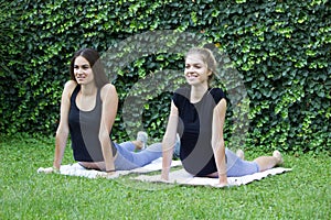 Girls yoga outside park