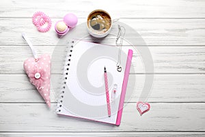 Girly accessories with blank notebook and cup of coffee on white