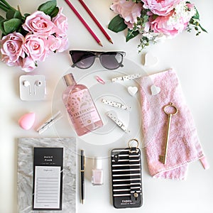 Girly flat lay with different accessories. Pink, rose, white, black.