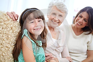 Girly time at grans. Portrait of a cute little girl spending time with her mother and grandmother at home.