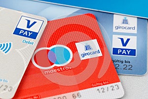 Girocards with maestro and v pay payment option. Selective focus on girocard word on sign logo. German bank cards