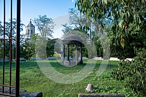 Girona, 22 October 2022: an old well is seen inside the Jardins dels Alemanys with the cathedral in the background