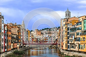 Girona cityscape with Eiffel bridge over Onyar river, Spain
