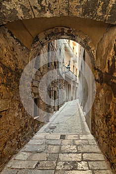 Girona, narrow medieval cobblestone street, old Jewish Quarter