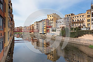 Girona riverside view with colorful houses along the Onyar river and Eiffel Bridge , Catalonia, Spain