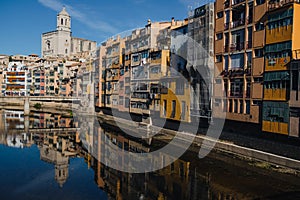 Girona, Spain on 22 October 2022: Colorful yellow and orange houses in historical jewish quarter of Girona, Catalonia, Spain