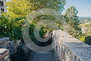 Girona, Spain, 22 October 2022: Girona old City Walls Walkway on sunny summer day, known as Passeig de la Muralla. Old roman walls