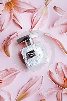 GIRONA, SPAIN - MARCH 9, 2020: perfume Bella Blanca by Oscar de la Renta surrounded with flowers and petals on pink photo