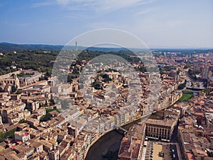 Girona - town in Catalonia, Spain. Onyar River bridge, colorful mediterranean architecture. Prominent cathedral