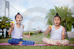 Girs play and Enjoy activities Blow bubbles in the park , Friend sister