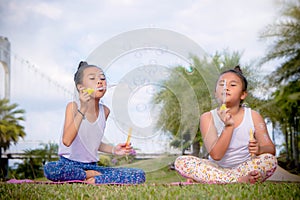Girs play and Enjoy activities Blow bubbles in the park , Friendship in Children`s Day
