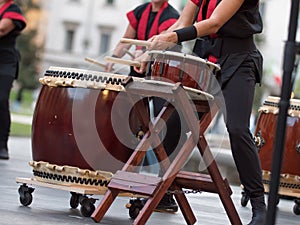 Girsl Playing Drums of Japanese Musical Tradition during a Public Outdoor Event